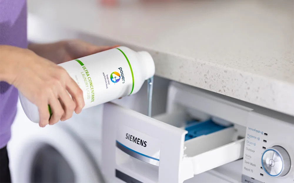 Effective Laundry Care with Power of 4 and Siemens Washing Machines Power of 4 laundry liquid being poured into a Siemens washing machine for effective cleaning