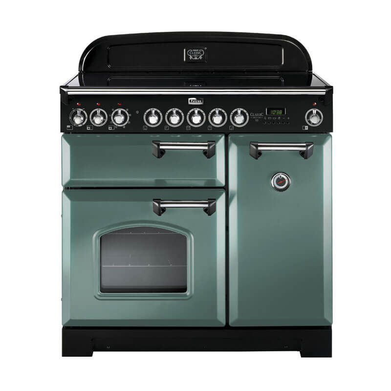 Falcon Classic Deluxe CDL90EIMG-CH 90cm Mineral Green & Chrome Induction Range Cooker standing in a modern kitchen, featuring a stainless steel finish, multiple ovens, and a sleek induction cooktop.