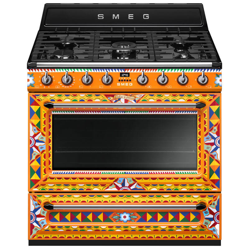 Smeg D&G TRA90DGC9 90cm Dual Fuel Gas Cooker in vibrant orange, showcasing multiple cooking appliances with a modern design.